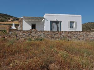 a house on a hill with a stone wall at Bonatsa House in Agios Georgios
