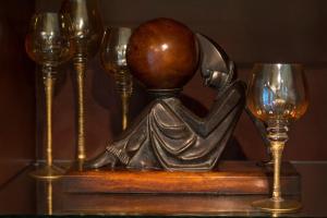 a statue of a man with a phone and two wine glasses at The Gardens Hotel in Key West