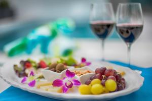 a plate of food with two glasses of wine at The Gardens Hotel in Key West