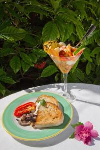 a plate of food with a sandwich and a drink at The Gardens Hotel in Key West