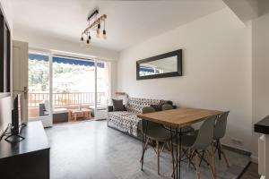 a living room with a table and a couch at Beautiful Apartment near Monaco in Roquebrune-Cap-Martin