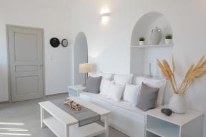 a white living room with a white couch and a table at Bonatsa House in Agios Georgios
