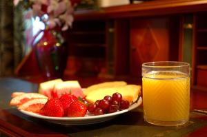 a plate of fruit and a glass of orange juice at The Gardens Hotel in Key West