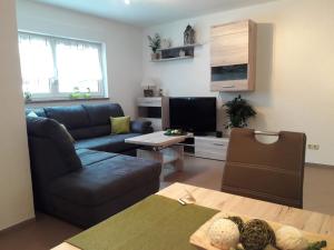 a living room with a couch and a tv at Ferienwohnung Rockmann in Kirchenlamitz