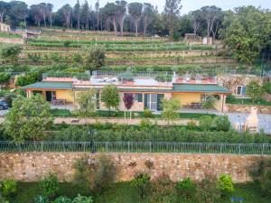 a house on a hill with a garden at Borgo dell'Uccellaia - Smeraldo - Ametista in Marciana Marina