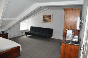 a living room with a couch and a bed at Rooms36 in Keswick