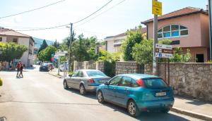 two cars parked on the side of a street at Guesthouse Stari Grad in Mostar