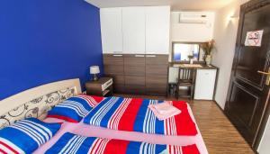 a bedroom with a bed with a red and blue at Guesthouse Stari Grad in Mostar