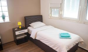 a bedroom with a bed with a blue towel on it at Guesthouse Stari Grad in Mostar