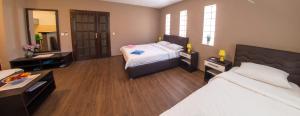 a hotel room with two beds and a mirror at Guesthouse Stari Grad in Mostar