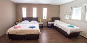 a bedroom with two beds with towels on them at Guesthouse Stari Grad in Mostar