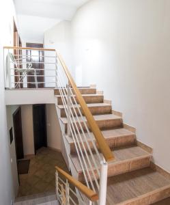 a staircase in a house with wooden railings at Guesthouse Stari Grad in Mostar