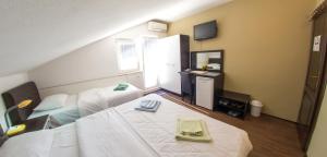 a hotel room with two beds and a mirror at Guesthouse Stari Grad in Mostar