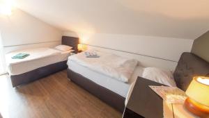 a small room with two beds and a lamp at Guesthouse Stari Grad in Mostar