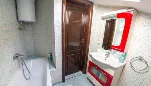 a bathroom with a sink and a toilet and a mirror at Guesthouse Stari Grad in Mostar