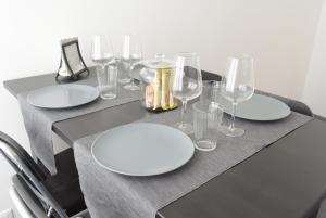 a black table with white plates and glasses on it at Caselita in Palermo