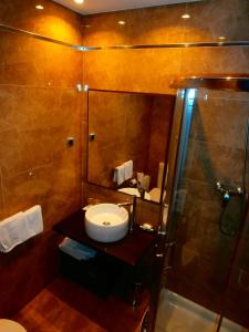 a bathroom with a sink and a shower at Casa Rural Telleri in Sopelana