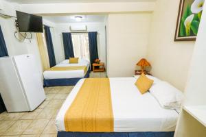 Postel nebo postele na pokoji v ubytování Hotel Flor Blanca