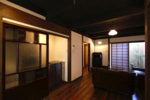 a room with a kitchen and a living room with a unintention at Azuki an Machiya House in Kyoto