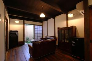 a living room with a couch and a table at Azuki an Machiya House in Kyoto