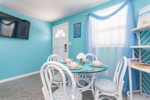 a blue dining room with a table and chairs at Villa Serenity, Pet Friendly in Panama City Beach