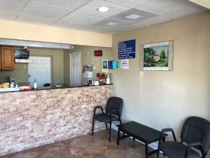 a waiting room with chairs and a counter at La Bella Inn in Tavares