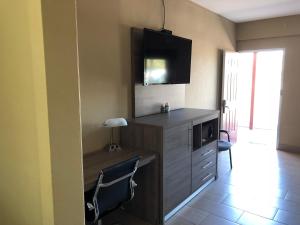 a kitchen with a desk with a microwave and a tv at La Bella Inn in Tavares