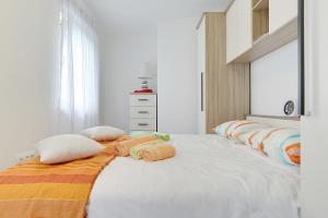 a bedroom with a large bed with pillows on it at Apartments Elviana in Pula