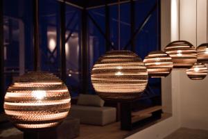 a group of lights hanging from a wall at ION Adventure Hotel, Nesjavellir, a Member of Design Hotels in Nesjavellir
