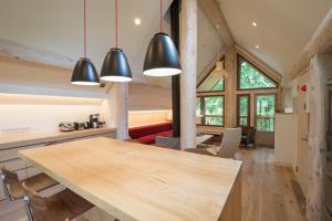 a kitchen and dining room with a large wooden table at Koho in Niseko