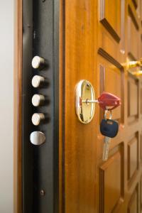 a door with a lock on it with a key at Athens spacious apartment in Athens