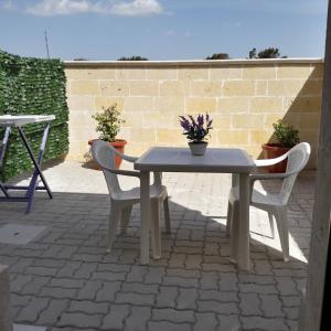 a table and two chairs on a patio at B&B Letizia in Marina di Lizzano
