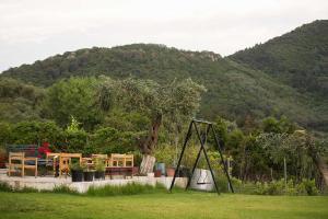 a park with a playground with a table and a swing at Areti Studios in Paramonas