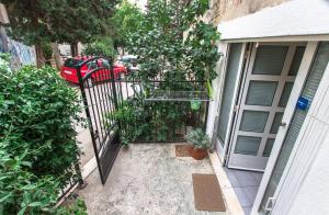 a gate to a house with a car parked next to it at Apartment Skeja in Split
