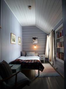 a bedroom with a bed and a book shelf at Kvebergsøya Gard in Grimsbu +25 photos