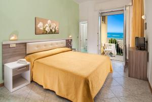 a bedroom with a bed and a view of the ocean at Hotel Gloria in Gabicce Mare +113 photos