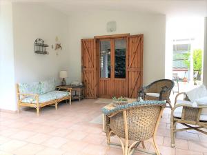 a living room with a couch and a table and chairs at Salento Sunny House in Leporano