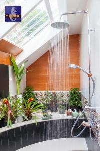 a bathroom with a shower with plants in it at Marine Chaweng Beach Resort in Chaweng