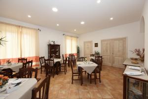 a restaurant with tables and chairs in a room at Guest House Villabianca in La Maddalena