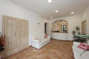 Guest House Villabianca في لا ماداّلينا: غرفة معيشة مع أريكة بيضاء وطاولة