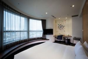 Rúm í herbergi á Merryday Hotel Banqiao