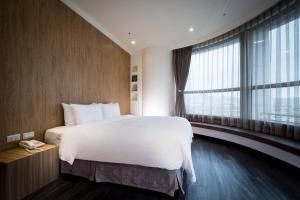 Rúm í herbergi á Merryday Hotel Banqiao