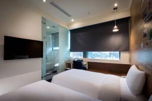 Rúm í herbergi á Merryday Hotel Banqiao