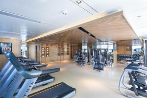 a gym with treadmills and cardio equipment in a room at Jinan Inzone Royal Plaza Hotels in Jinan