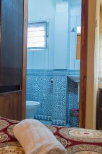 a bathroom with a shower and a toilet in it at Daher Guest House Nazareth in Nazareth