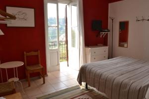 a bedroom with a bed and a table and a window at Bed & Breakfast A Casa Mia in Bergamo