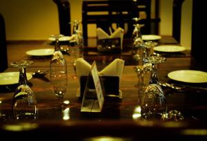 a wooden table with wine glasses and plates on it at Jade Vine Resort in Shogi +18 photos