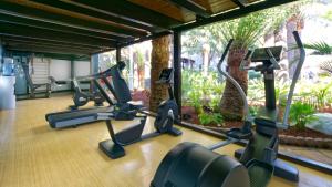 einen Fitnessraum mit mehreren Heimtrainern in einem Raum in der Unterkunft Hotel Parque Tropical in Playa del Ingles