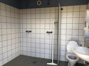 a bathroom with a toilet and a sink at HYGGE Strand Camping in Odder