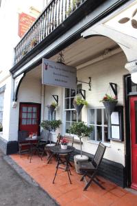 a group of chairs and tables outside of a building at The Lorna Doone Hotel in Porlock +46 photos